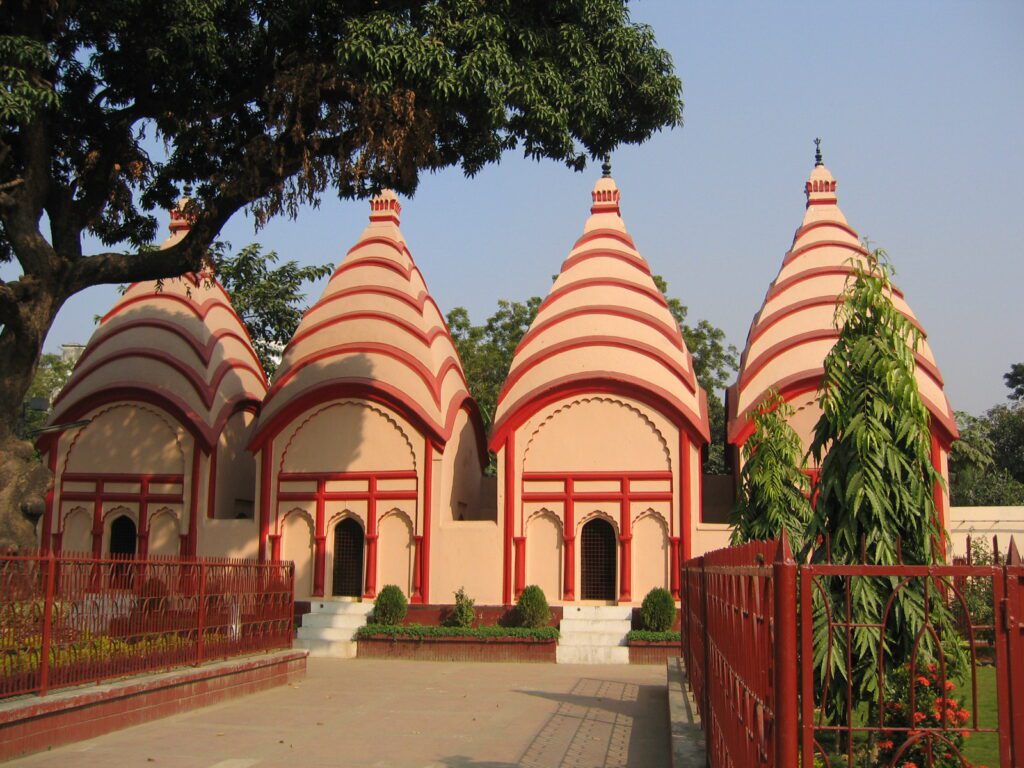 Four ancient Shiva temples at Dhakeshwari National Temple in Dhaka, a key cultural site on the Trip Glider heritage tour.