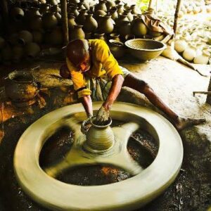 Traditional artisans hand-shaping clay pots in a pottery village near Dhaka during a Trip Glider cultural heritage tour.